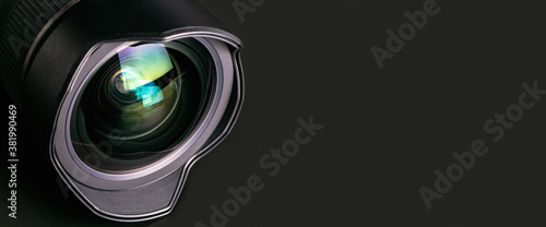 Camera lens on a black background. Wide-angle close-up lens. Macro. Banner.