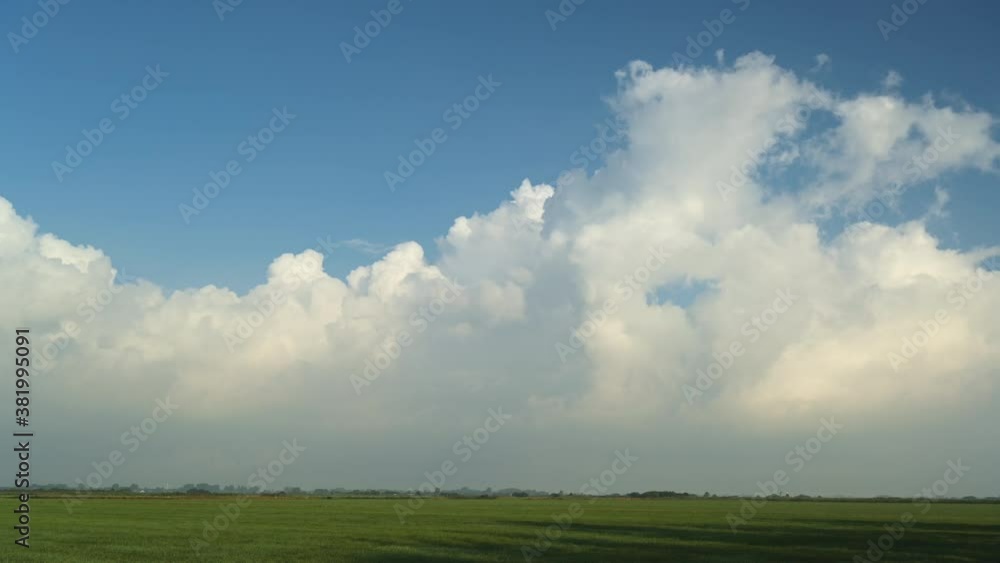 White cumulus clouds rolling above field White cumulus clouds rolling above field