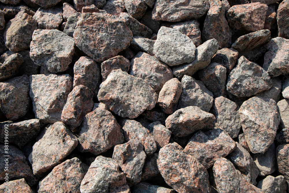 Large stones of gray granite close up. Chipped granite