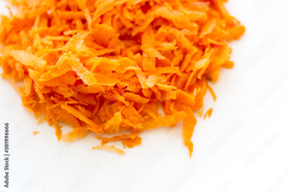 grated carrots on white background grated carrots on white background