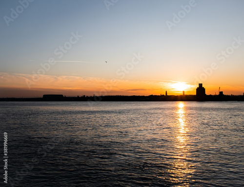 Liverpool, UK. Beautiful colorful long exposure shot of river Mersey from Albert Dock with smooth reflections of night lights from the other side of a shore. 
