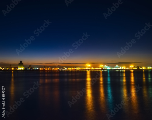 Liverpool, UK. Beautiful colorful long exposure shot of river Mersey from Albert Dock with smooth reflections of night lights from the other side of a shore.  © Ruslan
