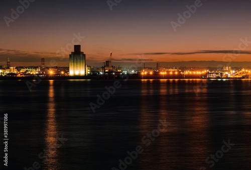 Liverpool, UK. Beautiful colorful long exposure shot of river Mersey from Albert Dock with smooth reflections of night lights from the other side of a shore. 