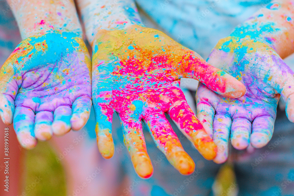 children's hands with Holi paints