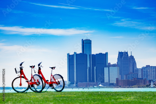 City bicycles on Sunset Point over Detroit river and view of downtown on sunny day from Belle Isle © Sergey Novikov
