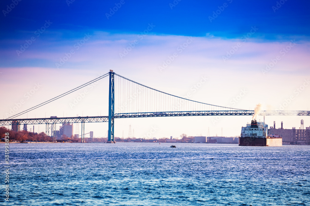 Ambassador Bridge view from Detroit, MI USA to Windsor Ontario Canada and freight boat