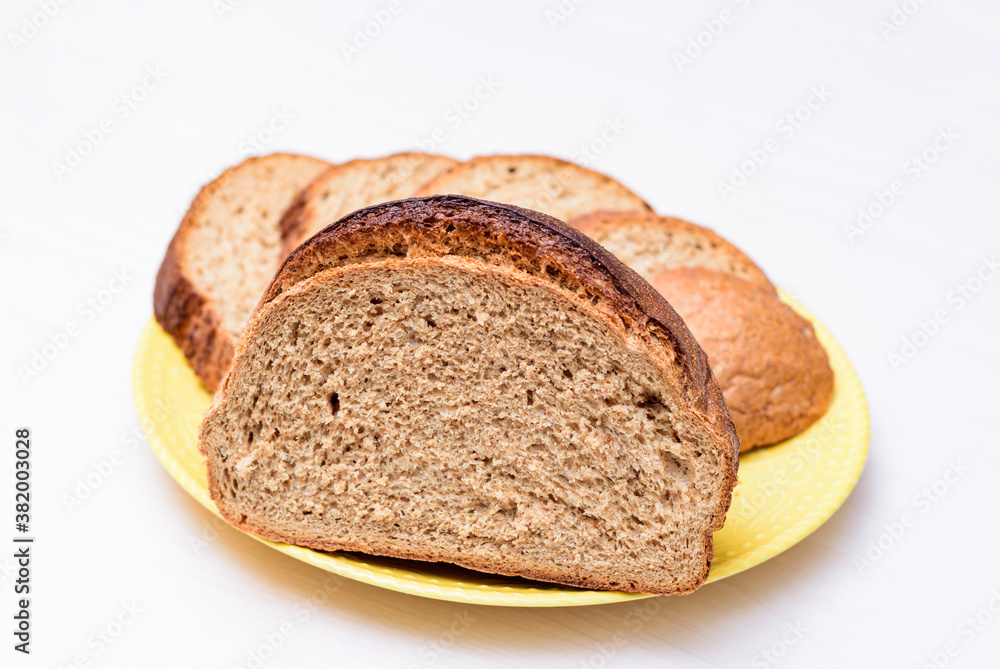 fresh buckwheat bread served cut and sliced on the white table. white background close-up, isolated.