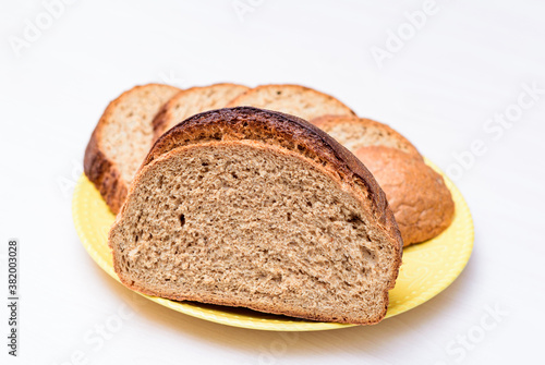 fresh buckwheat bread served cut and sliced on the white table. white background close-up, isolated.