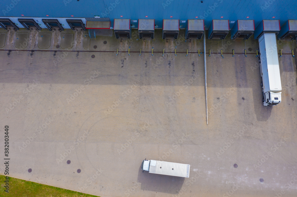 Aerial view of goods warehouse. Logistics center in industrial city zone from drone view. Aerial view of goods warehouse. Logistics center in industrial city zone from drone view.