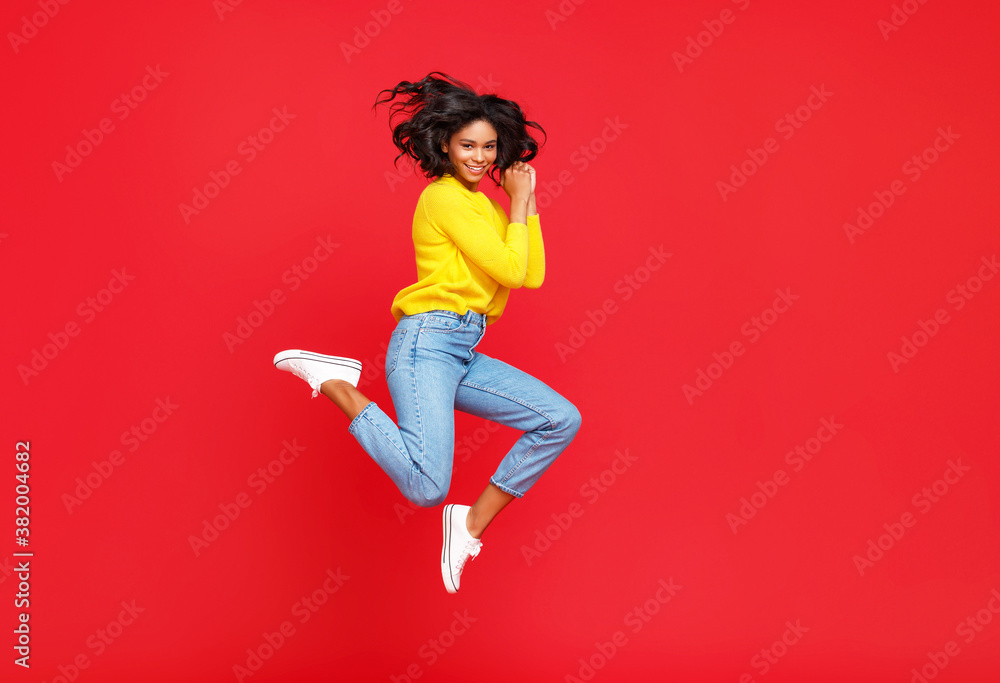 Happy ethnic woman smiling and jumping.