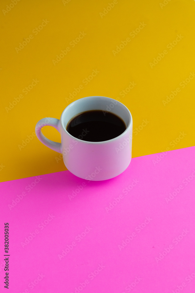 cup of coffee with yellow and pink background cup of coffee with yellow and pink background