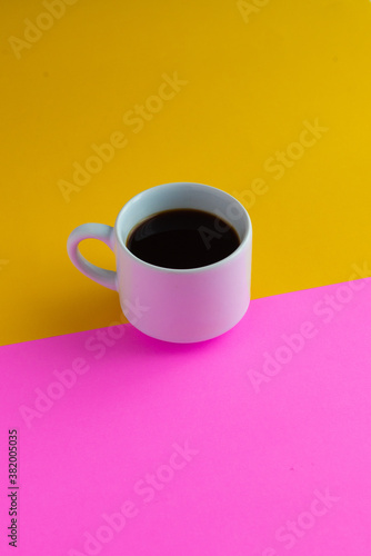 cup of coffee with yellow and pink background