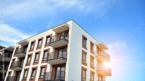 Apartment residential house and home facade architecture and outdoor facilities. Blue sky on the background. Sunlight