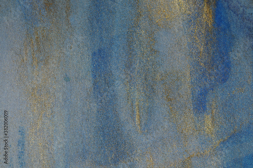 Grunge watercolor background on paper stains of shiny paint with blue.