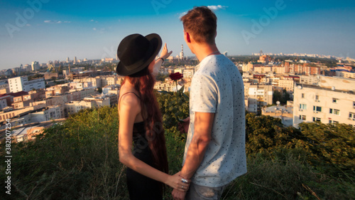 young couple, city view, girl shows city view from a height (ID: 382007254)