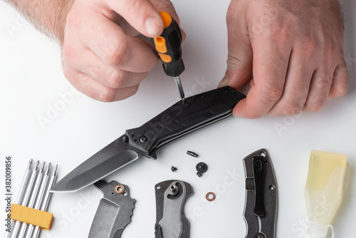Repairman unscrewing the handle of a pocket knife