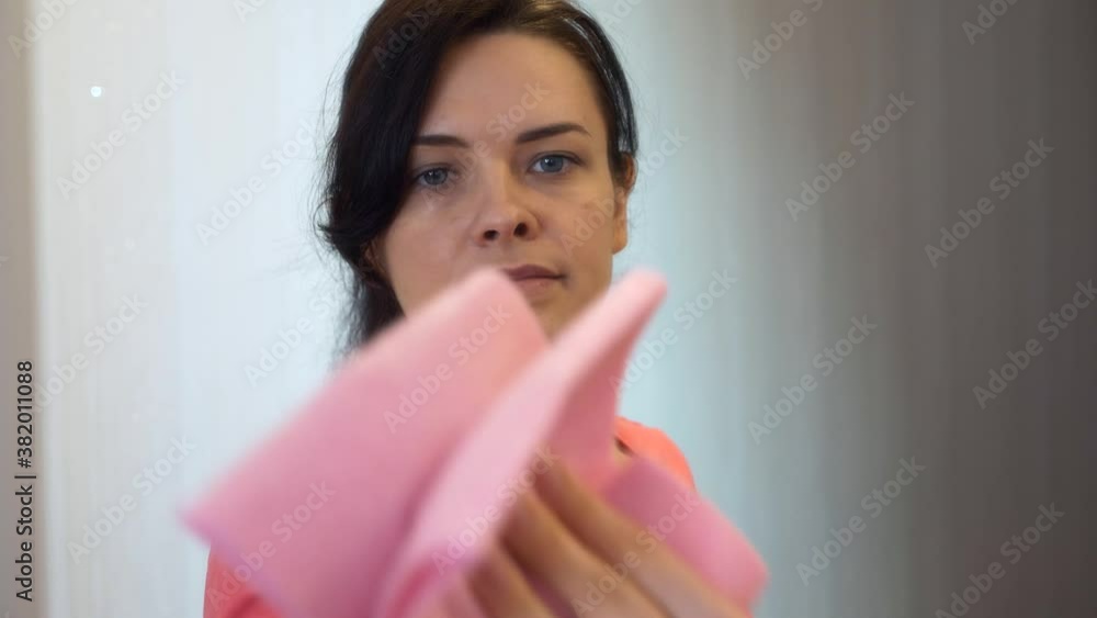 Young Woman House Worker is Cleaning House Wiping Dust Mirror Wardrobe at Home. 2x Slow motion 60 fps 4K Young Woman House Worker is Cleaning House Wiping Dust Mirror Wardrobe at Home. 2x Slow motion 60 fps 4K