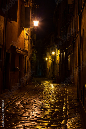 Scene of a cobblestoned street in the historic center of Rovinj in Croatia during night