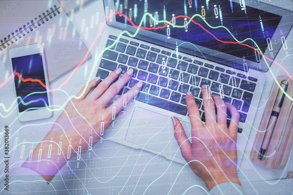 Double exposure of woman hands working on computer and forex graph hologram drawing. Top View. Financial analysis concept. Double exposure of woman hands working on computer and forex graph hologram drawing. Top View. Financial analysis concept.