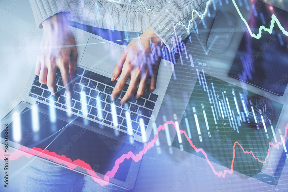 Multi exposure of woman hands working on computer and forex chart hologram drawing. Top View. Financial analysis concept. Multi exposure of woman hands working on computer and forex chart hologram drawing. Top View. Financial analysis concept.