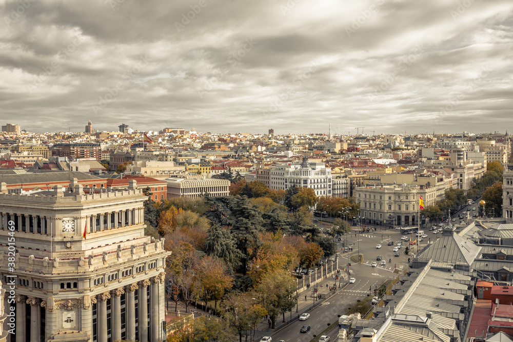 Obraz premium Looking down a wide boulevard over several buildings in urban Madrid Spain