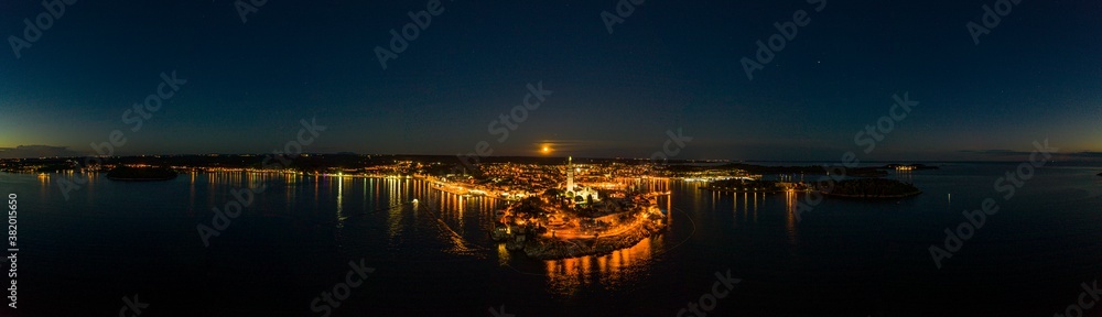 Panoramic aerial drone picture of the historic city Rovinj and harbor with full moon in Croatia during sunset