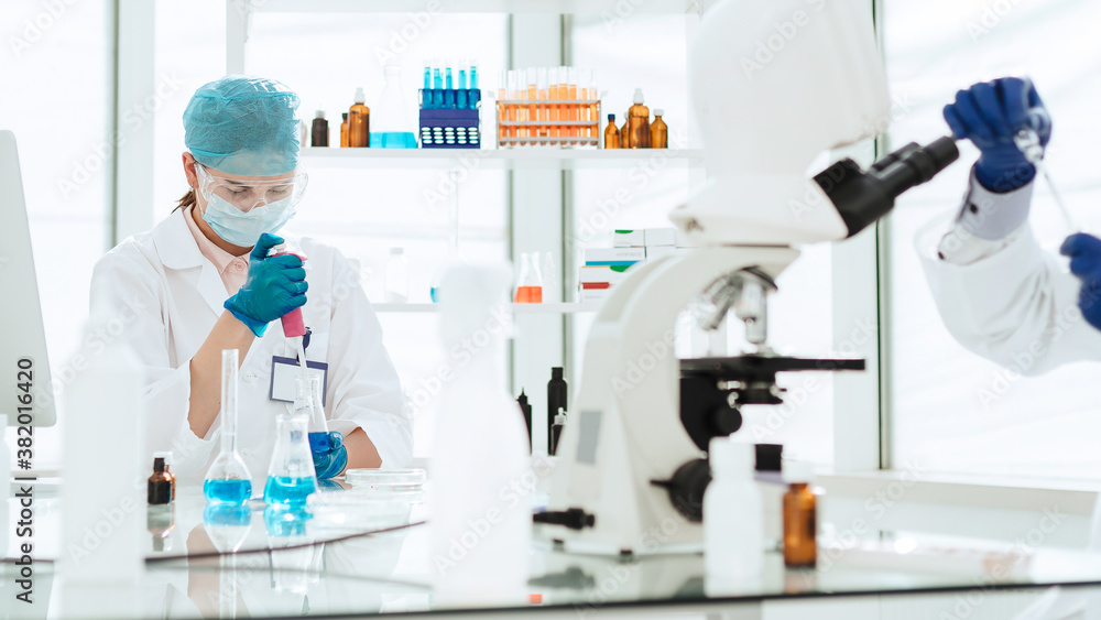 close up. a group of scientists are testing new drugs. close up. a group of scientists are testing new drugs.