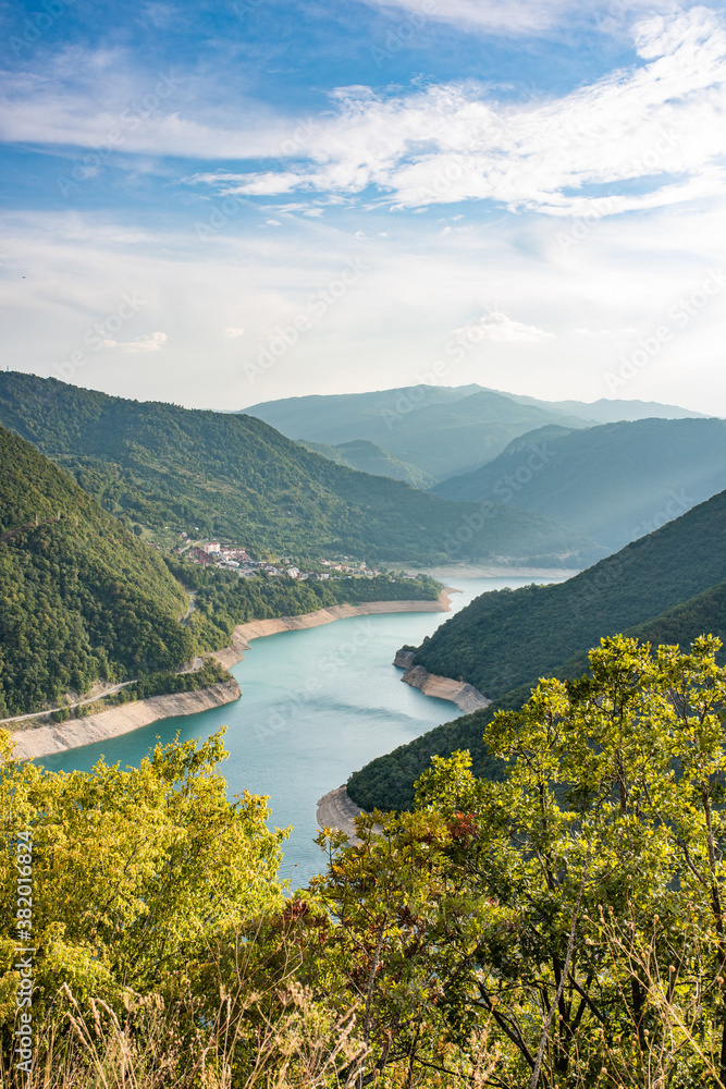 Fototapeta premium Lake Piva or Pivsko jezero artificial lake, Montenegro. View to Pluzine town from top of serpentine road.