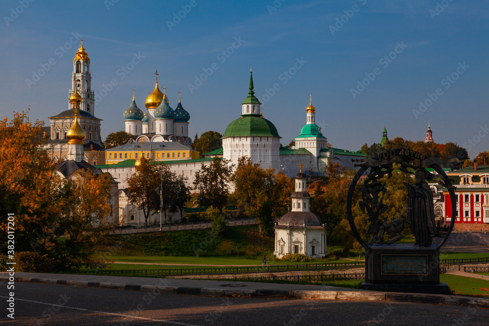 View of the Trinity-Sergius Lavra (Sergiev Posad, Russia). In the foreground there is a stele with an inscription in Russian 