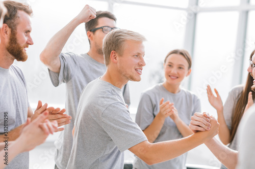 group of happy students applauding the contestants