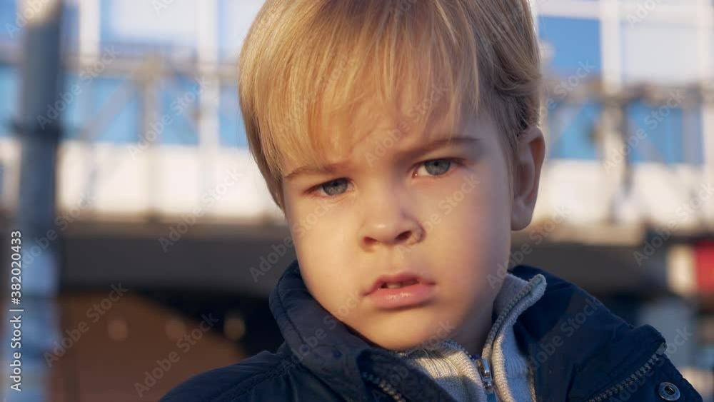 Portrait Serious Blond Child. Thoughtful Pensive Look. Cute Toddler Face Expression Emotion. Winter City Urban Background. 2x Slow motion 60 fps 4K Portrait Serious Blond Child. Thoughtful Pensive Look. Cute Toddler Face Expression Emotion. Winter City Urban Background. 2x Slow motion 60 fps 4K