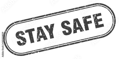 stay safe stamp. rounded grunge textured sign. Label