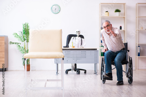 Old man in wheel-chair visiting dead doctor © Elnur