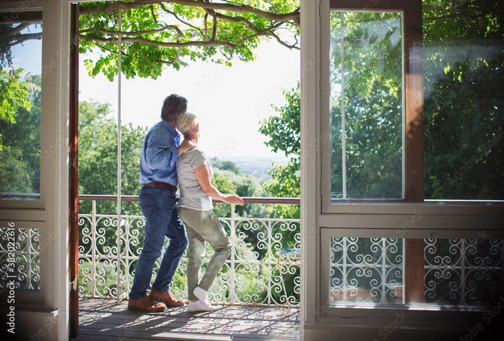 Affectionate senior couple relaxing on sunny balcony Affectionate senior couple relaxing on sunny balcony