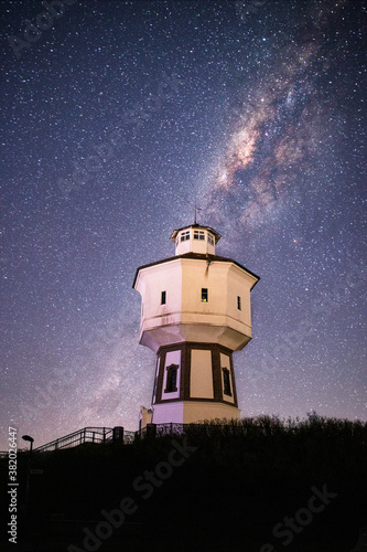 Langeoog Wasserturn - Watertower at night with the Milky way galaxy and a bright night sky in the background