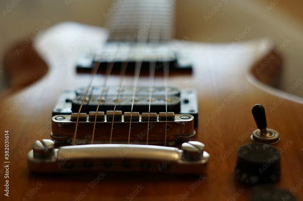 Streams and Bridges. Closeup shot of Washburn Idol WI-64 electric guitar with Tune-o-matic bridge Streams and Bridges. Closeup shot of Washburn Idol WI-64 electric guitar with Tune-o-matic bridge