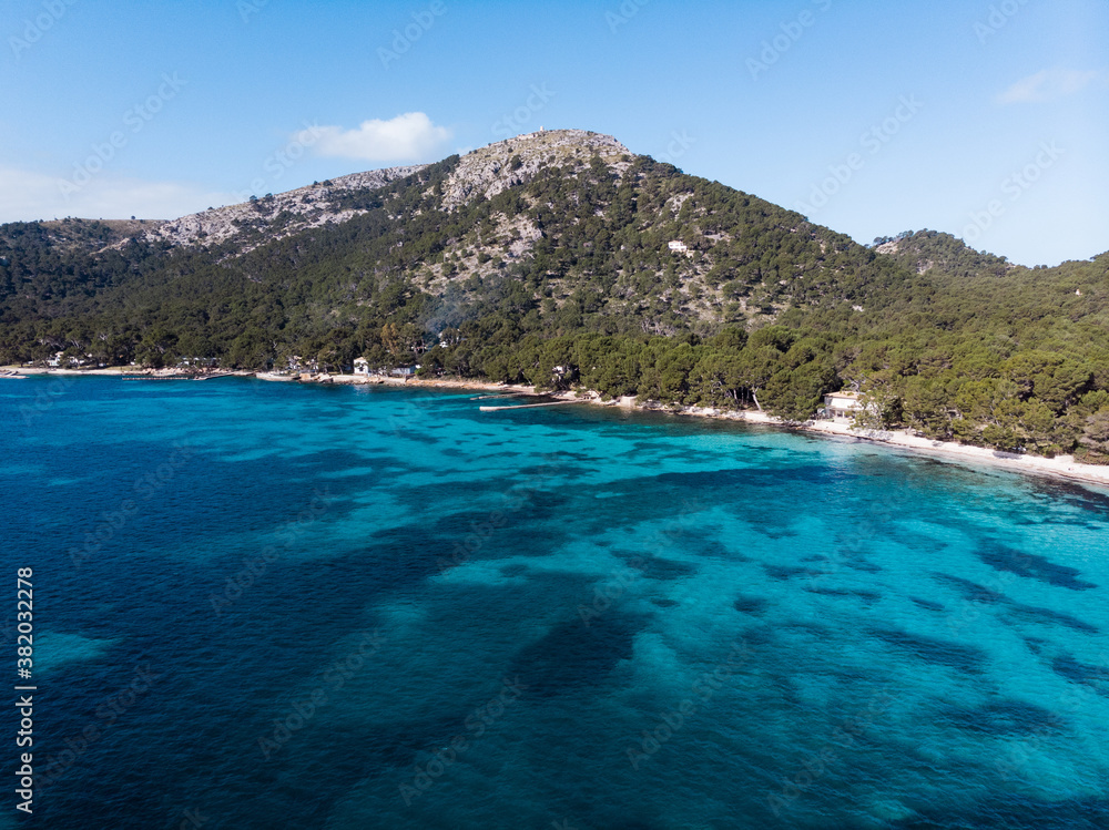 Aerial drone view, beautiful scenic landscape view of mountains and blue crystal clear water on  the shore of Mallorca Island, Balearic Island, Spain
