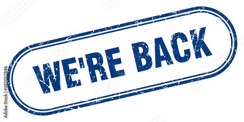 we're back stamp. rounded grunge textured sign. Label