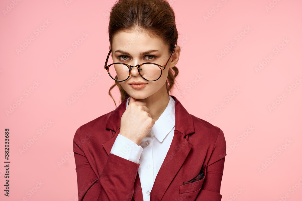 Elegant woman in red jacket glasses office manager pink background