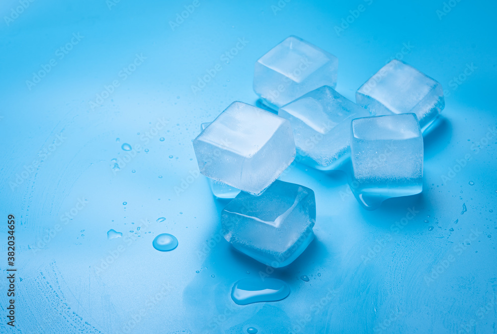 Ice cubes with water drops on a blue background Ice cubes with water drops on a blue background