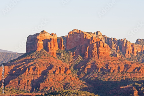 The evening sun illuminates Sedona's famous red rocks with Cathedral Rock in the foreground.
