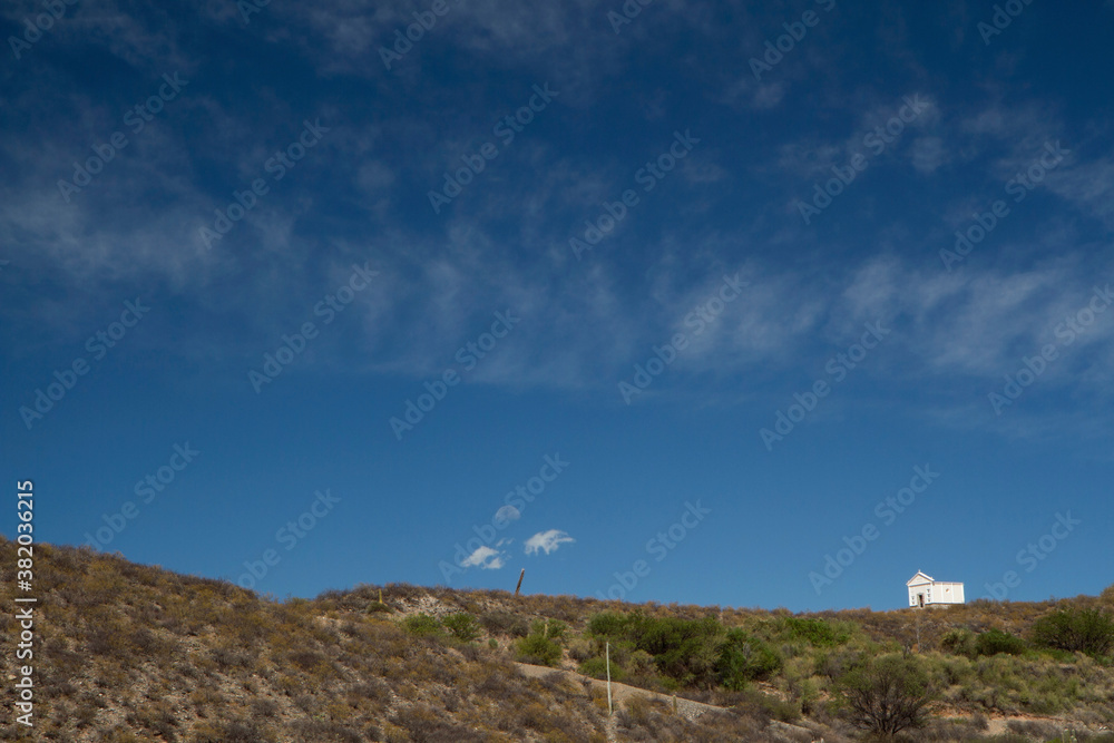 House of God. Allegoric view of a small chapel in the mountaintop under a beautiful deep blue sky. House of God. Allegoric view of a small chapel in the mountaintop under a beautiful deep blue sky.