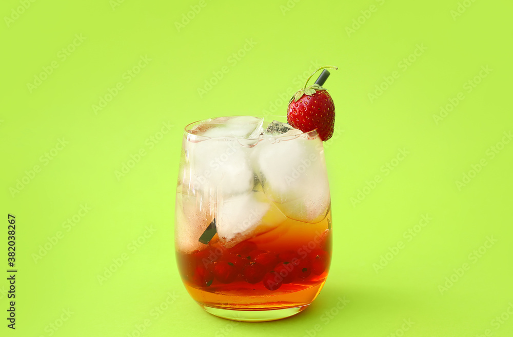 Glass of fresh mojito cocktail with berries on color background Glass of fresh mojito cocktail with berries on color background