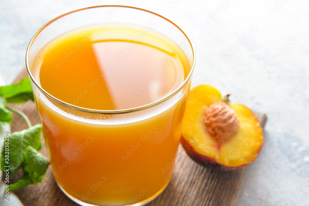 Fototapeta premium Glass of fresh peach juice on table