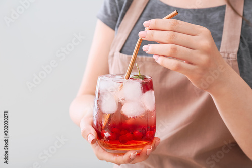 Woman with glass of fresh mojito cocktail, closeup