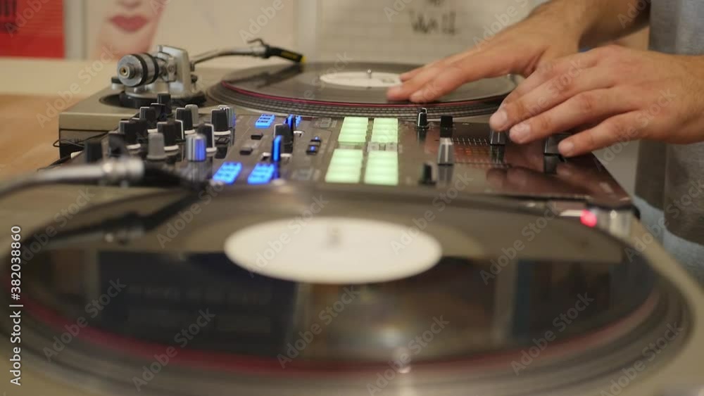 DJ Mixing And Scratching On Turn Table Focus Pull As He Switches Sides DJ Mixing And Scratching On Turn Table Focus Pull As He Switches Sides