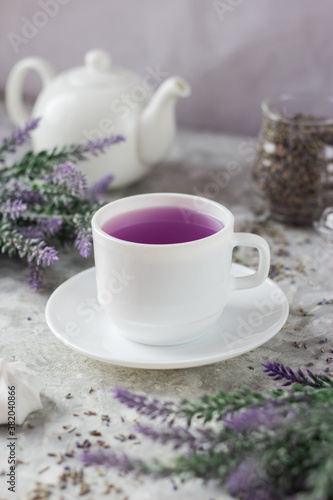 Wallpaper Mural lavender tea in a white mug. Purple tea in a mug on a light background stands on the table next to lavender flowers. Dried lavender flowers are brewed in a Cup. Torontodigital.ca