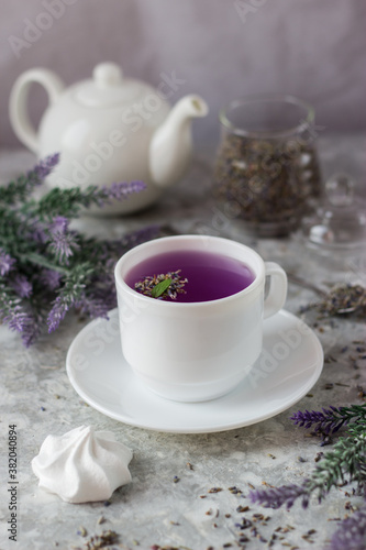 Wallpaper Mural lavender tea in a white mug. Purple tea in a mug on a light background stands on the table next to lavender flowers. Dried lavender flowers are brewed in a Cup. Torontodigital.ca