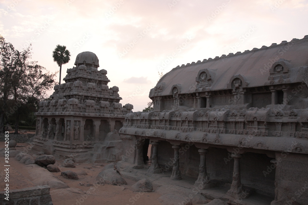 Fototapeta premium View of Ancient Monolithic temples Five Rathas (Indian: Pancha Rathas) of Mahapalipuram under sunset in Tamil Nadu, India