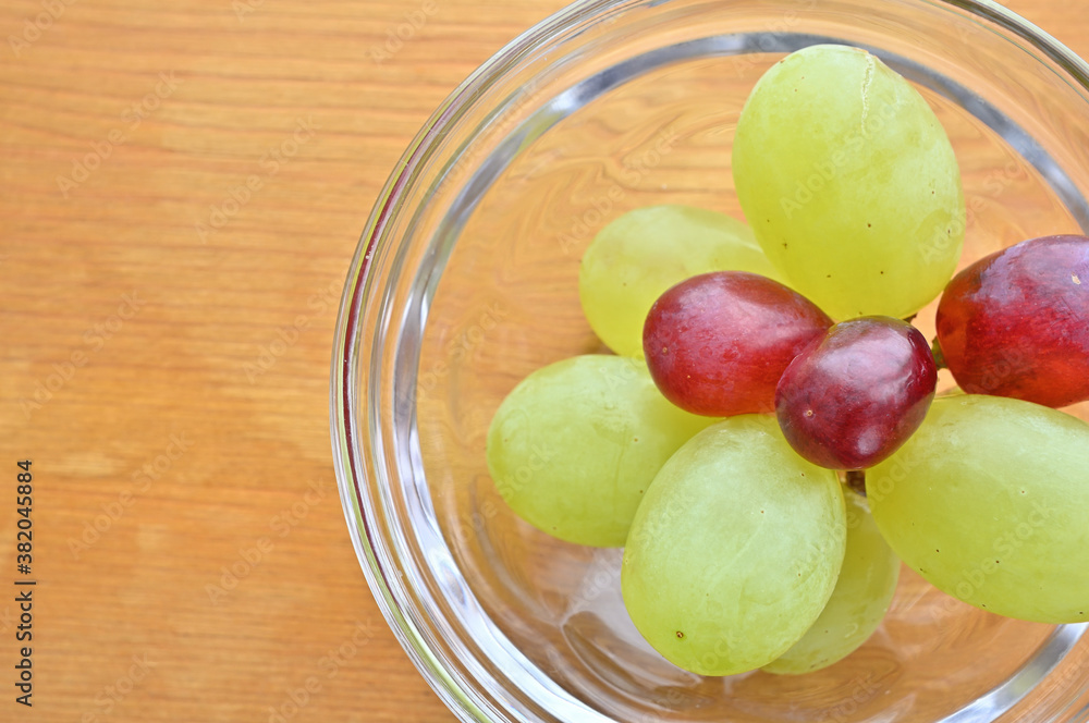 A small amount of grapes in a glass vessel. A small amount of grapes in a glass vessel.